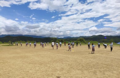 Children practicing throws at practice